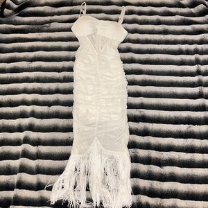 Sheer white scrunched dress with fringes.